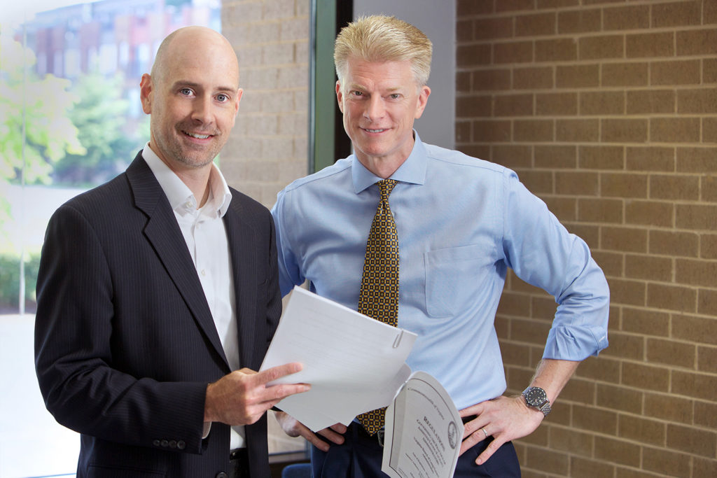 Two partners reviewing deal documents