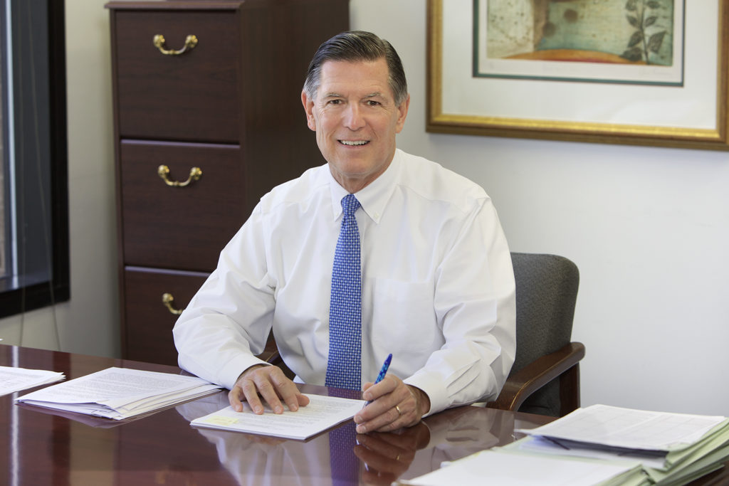 Wayne Tatusko at his desk reviewing documents