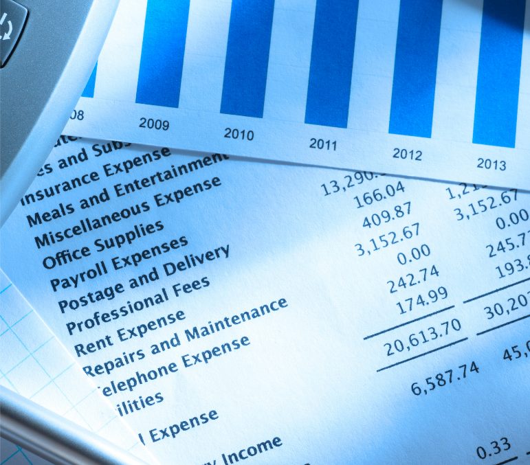 Financial statement and bar chart on a desk